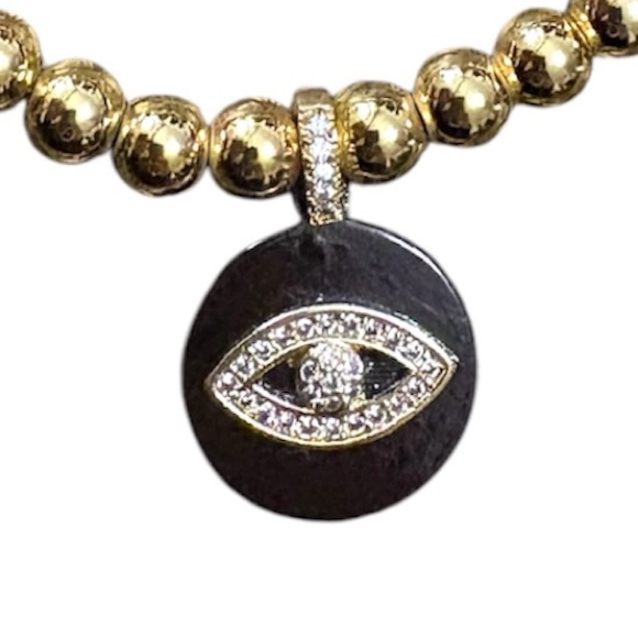 Gold tone beaded elastic bracelet with black and rhinestone evil eye pendant - Picture 2 of 4